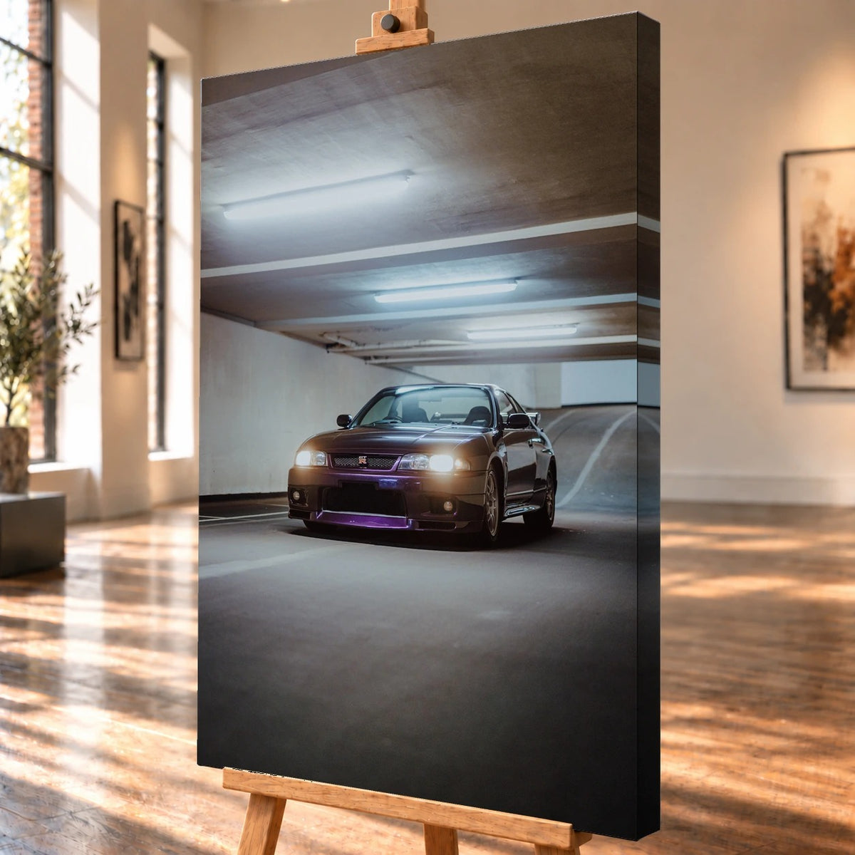 Schrägansicht einer hochformatigen Leinwand als Visualisierung auf einer Holzstaffelei; die bedruckte rechte Seitenkante ist sichtbar. Im Motiv ist ein dunkelvioletter Nissan Skyline GT-R R33 mit leuchtenden Scheinwerfern unter den Deckenröhren einer Tiefgarage zu sehen.