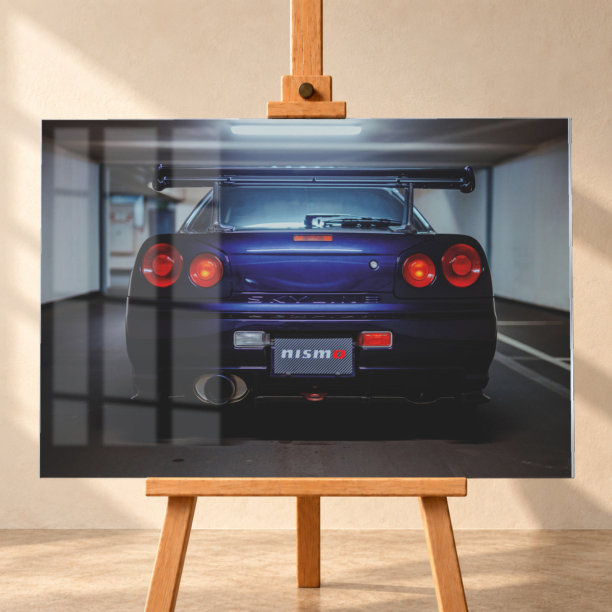 Zentrierte Heckansicht eines dunkelvioletten Nissan Skyline R34 in einer Parkgarage. Sichtbar sind vier runde rote Rückleuchten mit orangefarbenen inneren Leuchtelementen, ein großer Heckflügel, ein breites Auspuffendrohr links, ein Nismo-Schriftzug und kühles Deckenlicht über dem Fahrzeug; Visualisierung als Acrylglas-Wandbild, frontal auf einer Holzstaffelei.