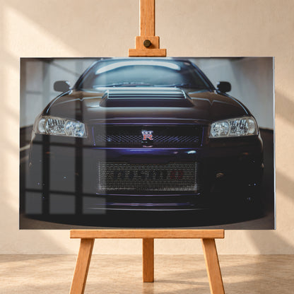 Symmetrische frontale Nahaufnahme eines dunkelvioletten Nissan Skyline R34 vor hellen Wänden. Sichtbar sind rechteckige Scheinwerfer, GT-R-Emblem, Hauben-Lufteinlass, Kühlergitter und die große untere Gitteröffnung; kühles Licht spiegelt sich auf Haube und Windschutzscheibe; Visualisierung als Acrylglas-Wandbild, frontal auf einer Holzstaffelei.