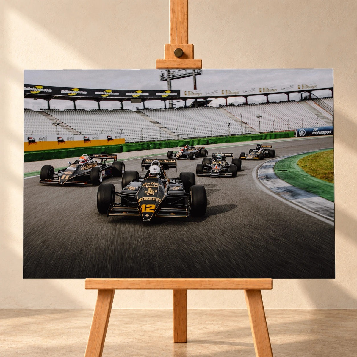 Fünf historische Lotus-Formelwagen fahren als Gruppe durch eine Rennstreckenkurve; schwarze Gold-Lackierungen und Startnummern sind deutlich erkennbar. Motiv „Trackside Story“ als Leinwand-Wandbild, frontal auf einer Holzstaffelei.