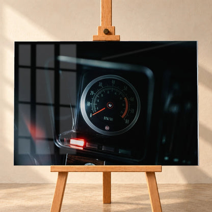 Ein einzelner Rundinstrument-Zähler leuchtet im dunklen Innenraum des Camaro Yenko; rote Kontrollleuchte und Skala sind klar sichtbar. Motiv „Silver Moment“ als Acrylglas-Wandbild, frontal auf einer Holzstaffelei.