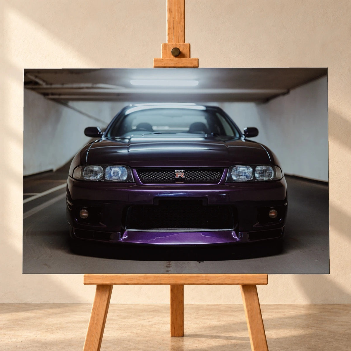 Der Nissan Skyline R33 ist frontal und nah unter Neonlicht fotografiert; Kühlergrill und violetter Splitter bilden eine klare horizontale Linie. Motiv „Skyline Moment“ als Leinwand-Wandbild, frontal auf einer Holzstaffelei.