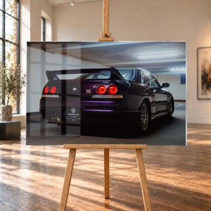 Der Nissan Skyline R33 steht schräg von hinten in einer Parkhauskurve; Rundlichter und Spoiler heben sich vom kühlen Beton ab. Motiv „Neon Story“ als Acrylglas-Wandbild, auf einer Holzstaffelei in einem hellen Galerieraum.