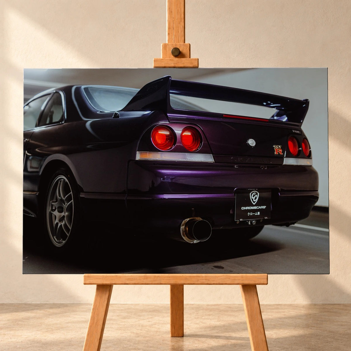 Die niedrige Heckperspektive des Nissan Skyline R33 hebt Spoiler, Rundlichter, Felgen und das große Endrohr hervor. Motiv „Skyline Drive“ als Leinwand-Wandbild, frontal auf einer Holzstaffelei.