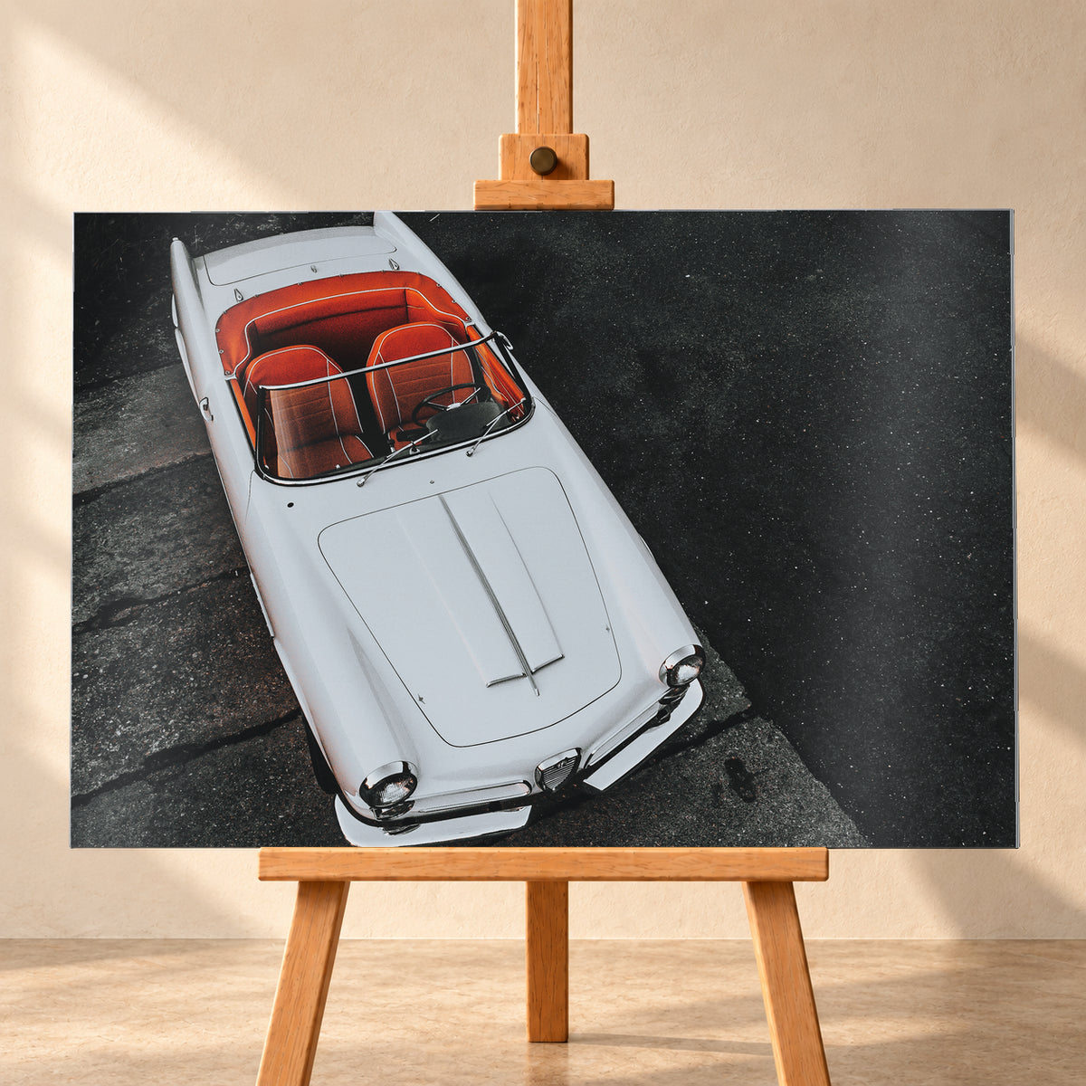 Heller Alfa Romeo 2000 Touring Spider in steiler Aufsicht, diagonal auf dunklem Asphalt; sichtbar sind das offene rot-orange Cockpit, Lenkrad, Windschutzscheibe, lange Motorhaube, runde Frontleuchten und Chromdetails; Visualisierung als Alu gebürstet-Wandbild, frontal auf einer Holzstaffelei.