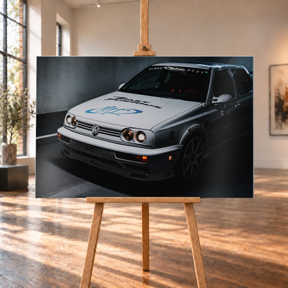 Heller Volkswagen Jetta in frontaler Dreiviertelansicht vor dunklem Hintergrund, mit eingeschalteten runden Frontscheinwerfern, orangefarbenen Leuchten, schwarzen und blauen Grafiken auf der Motorhaube sowie sichtbaren Aufklebern an Scheibe und Karosserie; Visualisierung als Alu gebürstet-Wandbild, auf einer Holzstaffelei in einem hellen Galerieraum.