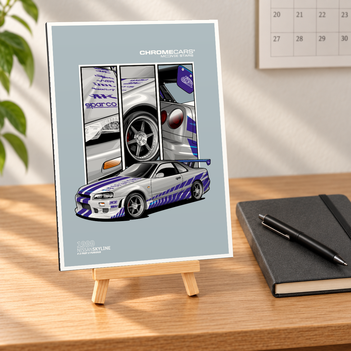 Mockup einer kleinen hochformatigen Alu-Dibond-Bildplatte auf einer Holzstaffelei, in naher, leicht schräger Vorderansicht auf einem Holzschreibtisch. Motiv: silberner Nissan Skyline mit blau-violetten Streifen in vorderer Dreiviertelansicht, dahinter drei Detailfelder mit Front, Rad und Heck auf graublauem Grund. Notizbuch mit Stift, Wandkalender und Pflanze bilden die Szenerie.